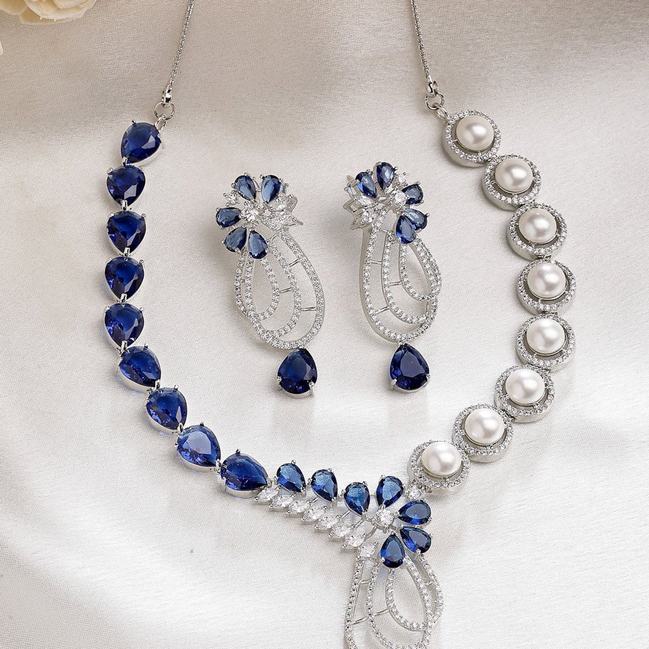Sukkhi Classic Tear Drop Round Design Rhodium Plated Cubic Zirconia & Pearl Studded Blue Brass Collar Necklace & Drop Earrings Jewellery Set for Women