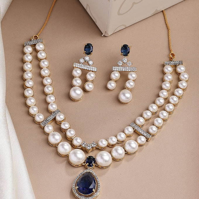 Sukkhi Glamorous Blue Pear Design Gold Plated CZ & Pearl Studded Brass Two Layered Collar Necklace with Drop Earrings Jewellery Set for Women
